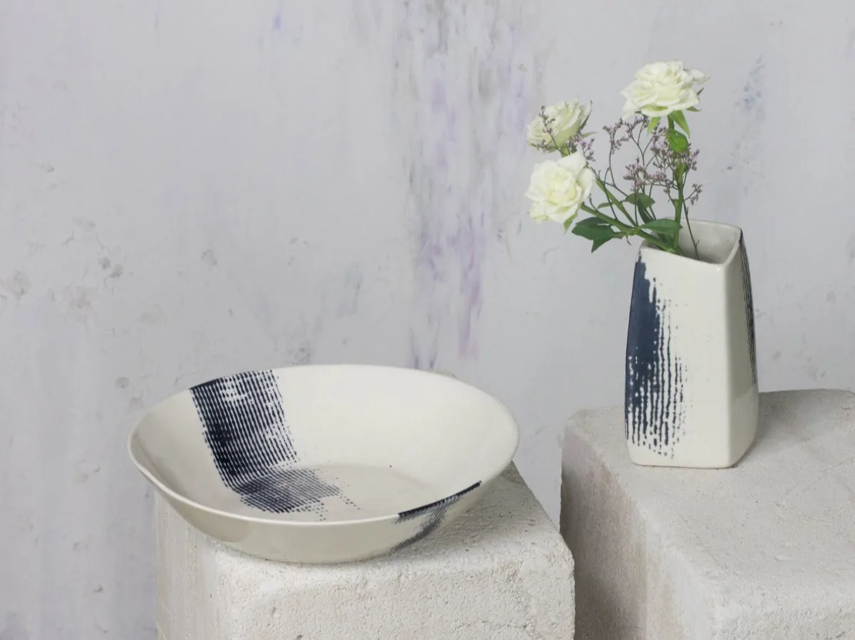 Striped indigo bowl and slim vase with white roses