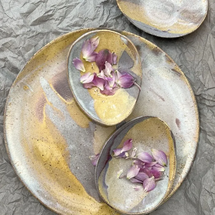 Plate and small dishes scattered with petals