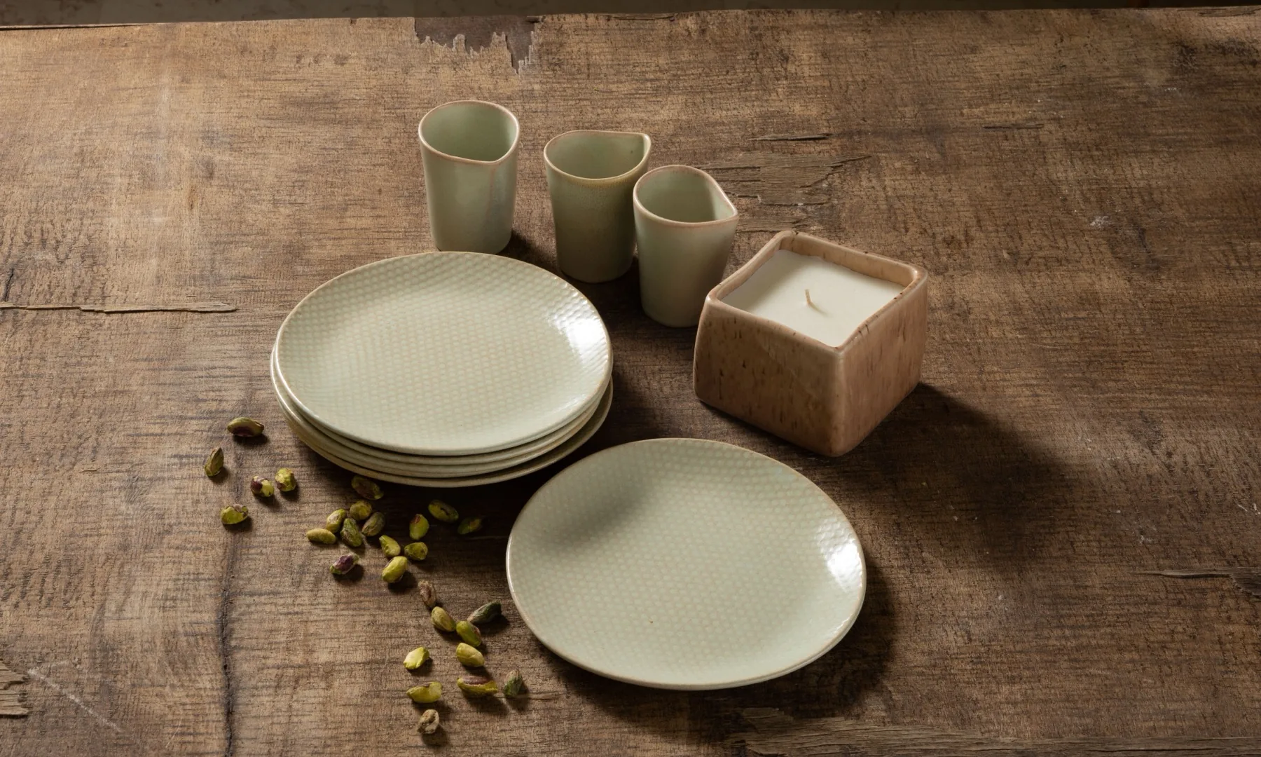 A small set arranged on weathered wood with pistachios