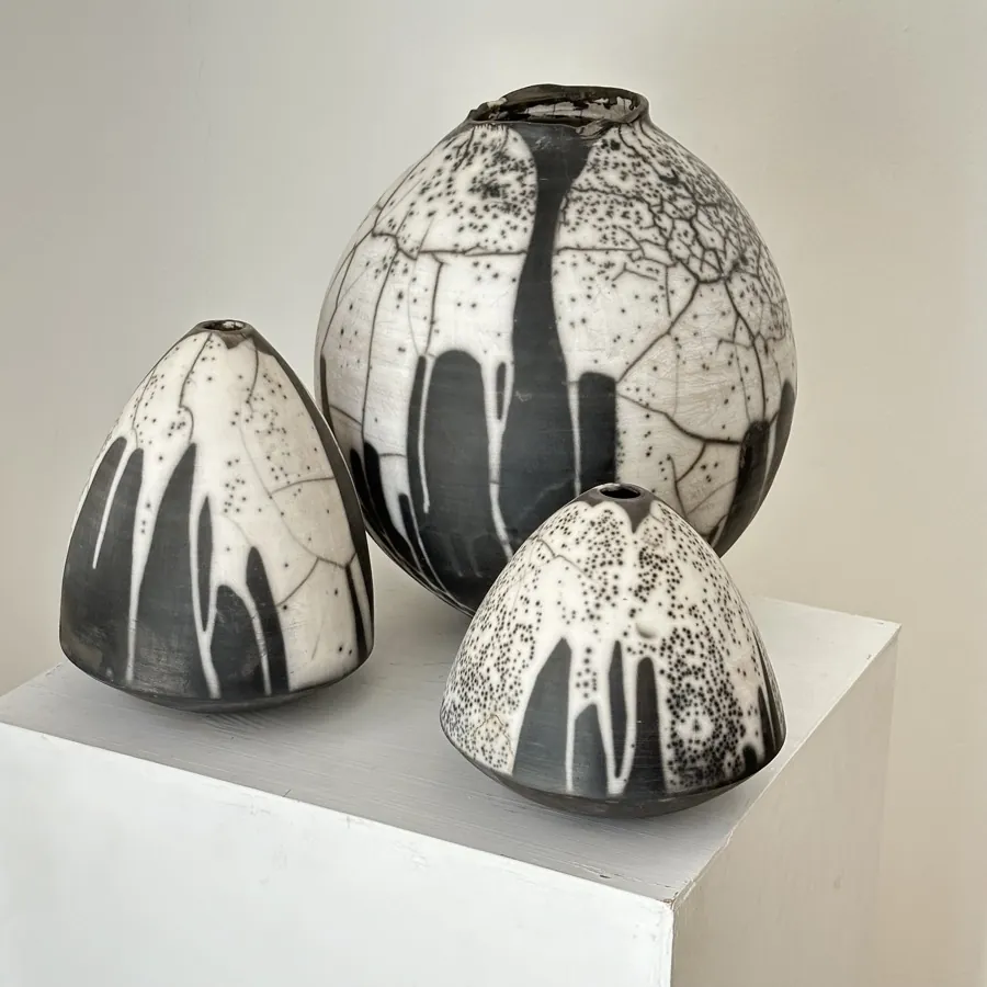 A trio of black and white raku vessels